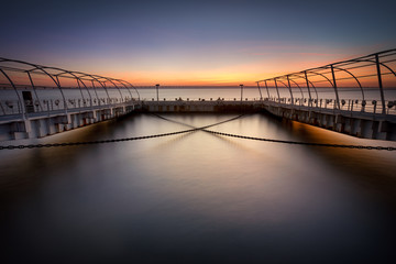 Fototapeta na wymiar The X chains, Pier in the city at sunrise