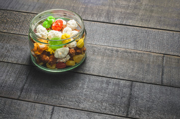 Bright colored candy, sweets, sweets  in a glass jar on a dark background