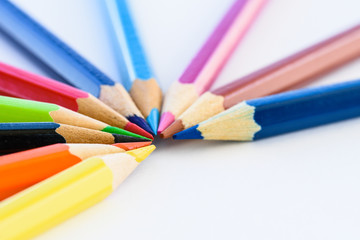Closeup different colored pencils on white background.