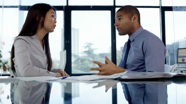  Business man & woman having an argument in office meeting