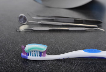 Tooth brush and paste with dental tools. Clean your teeth scene.