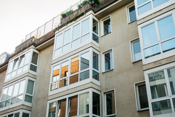 grey facaded apartment complex with big window balcony