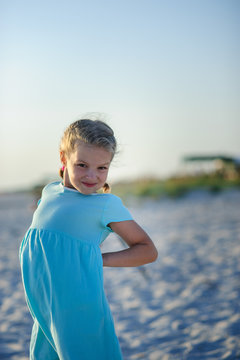 Portrait of a girl of 9-10 years in a blue dress.