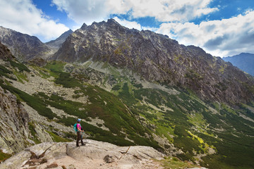Fototapeta na wymiar Hiking woman admiring the beauty of rocky Tatra mountains