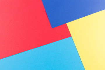 Color papers geometry flat composition background with yellow, red and blue tones