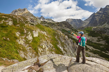 Naklejka premium Hiking woman admiring the beauty of rocky Tatra mountains
