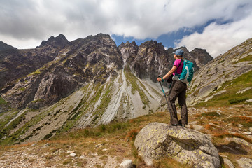 Fototapeta premium Hiking woman admiring the beauty of rocky Tatra mountains