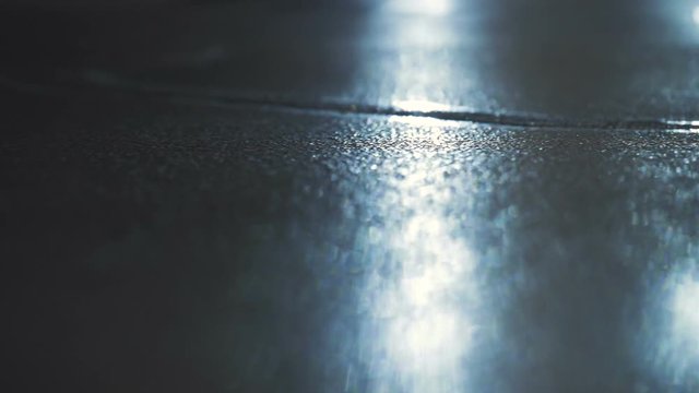 Car lights shining on dark cement 