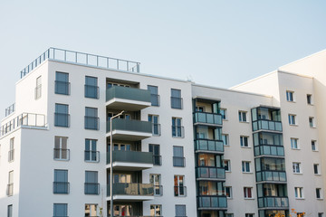 white modern plattenbau building with grey balcony