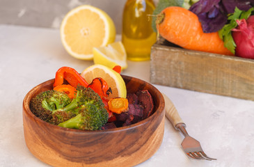 Vegetarian salad of baked vegetables in a wooden bowl