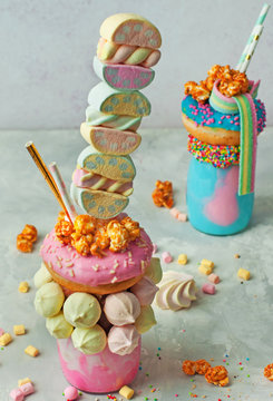 Freak shake topping with donut and marshmallow over grey background