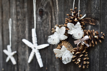 Handmade Christmas ornaments hanging on the rope on the rustic wooden background. Selective focus. 