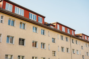 Fototapeta na wymiar orange apartment house with red roof