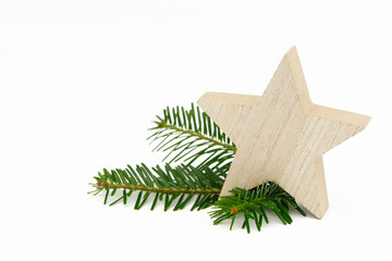 wooden xmas star and fir branch on white