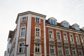 Fototapeta na wymiar red corner building with white stucco details