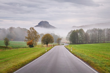 Autumn morning mist on the road in Germany