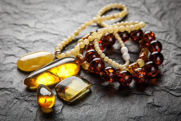 Amber jewelry on grey background