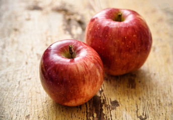 Bio red apples on rustic wooden background. Autumn fruits