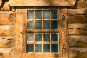 Front view of the windows in an old wooden house. Facade of an ancient timbered house