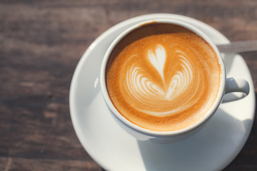 Cup of coffee latte, with heart shape.