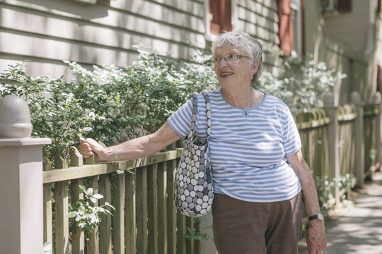 Portrait of a Senior Woman on Sidewalk of Residential Neighborhood