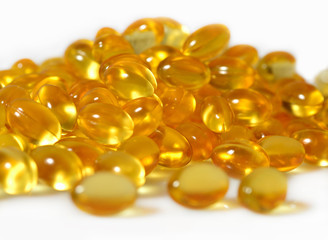 Omega-3 fish fat oil capsules close up on a white background.