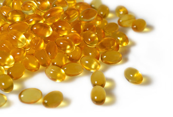 Omega-3 fish fat oil capsules close up on a white background.