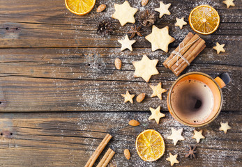Christmas gingerbread cookies stars on a wooden table and coffe, selective focus