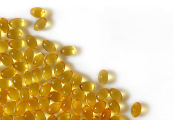 Omega-3 fish fat oil capsules close up on a white background.
