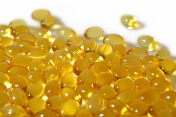 Omega-3 fish fat oil capsules close up on a white background.
