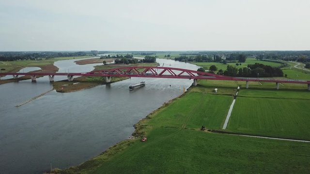 Aerial of train driving over a big bridge in the Netherlands over the river ijssel near Zwolle 