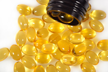 Omega-3 fish fat oil capsules in a bottle