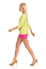 Beautiful Blond Woman In High Heels Is Walking Side View