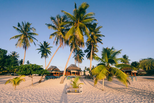 Beach huts - bungalows on a resort on beach of exotic tropical island