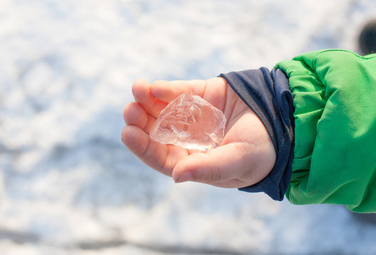 child holding ice cubes - winter