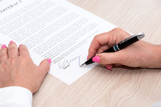 Woman signing a contract
