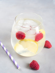 Cocktail with raspberries and lemon slices or infused detox water