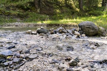 Stone dam across mountain stream in forest
