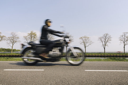Blurry image of a rider or a motorcyclist on a classic motor