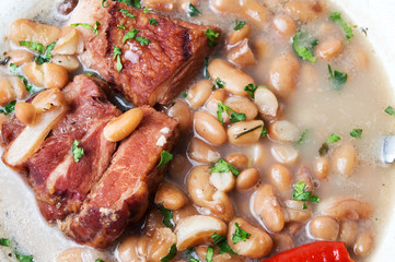 Boiled beans with meat on a plate