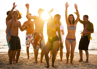 Fototapeta na wymiar A group of diverse people is having fun at the beach