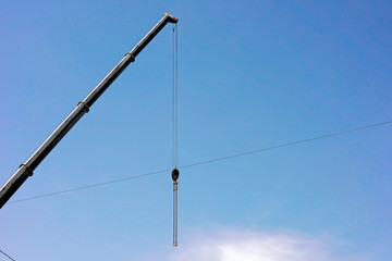 Arrow of a crane against the sky