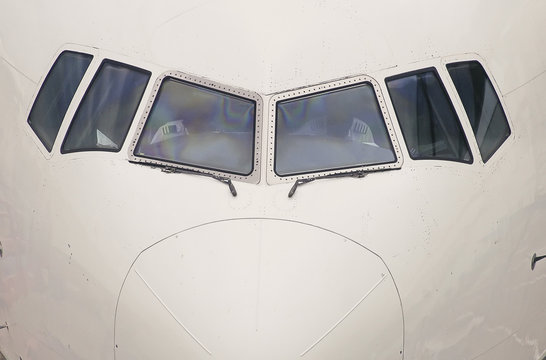 Front of commercial airplane with cockpit