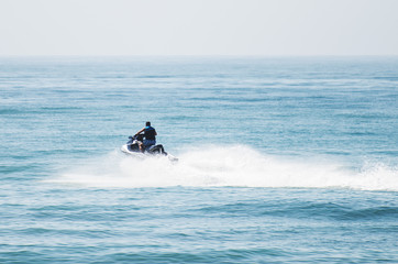 Man riding on water scooter in the sea.