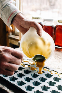 pouring maple sugar into mold for candy
