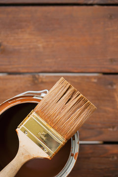 Staining: Used Brush Sits On Metal Can Of Stain