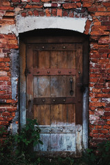 Old wooden door in a red face brick building