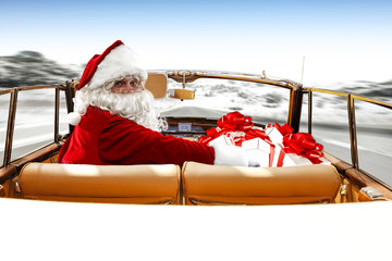santa claus in cabriolet on winter road 