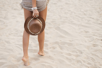 Leisure in summer - Beautiful of sexy women tan. relax on sandy beach with hat and coconut cocktail. vintage color styles