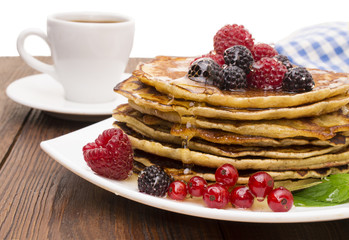 Delicious pancakes with berries and maple syrup